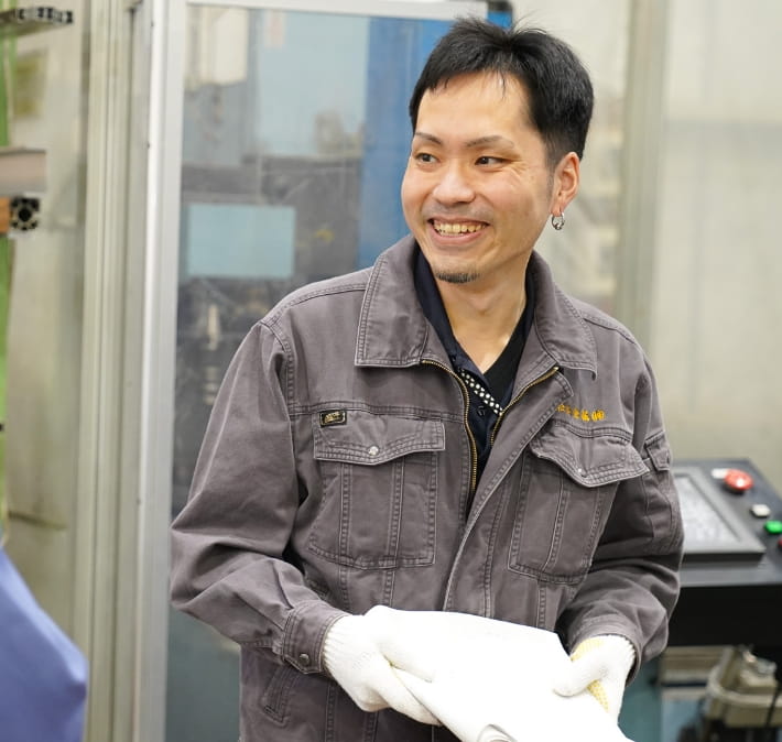 岐阜工場で勤務する男性社員が、笑顔で会話をする様子